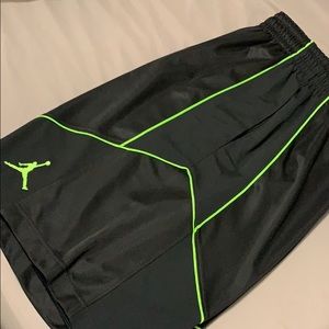 Black Jordan shorts with neon green accents